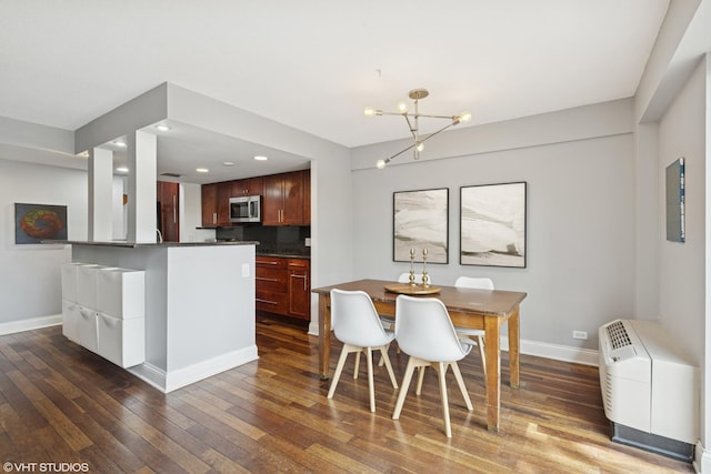 dining area with baseboards, a chandelier, wood-type flooring, and recessed lighting