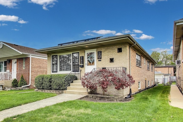 view of front of home featuring brick siding and a front lawn