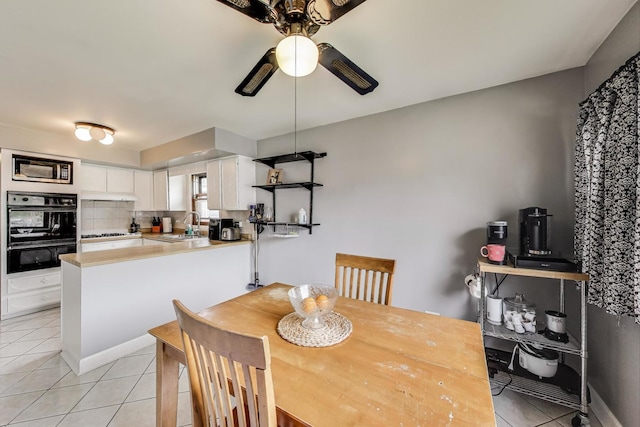 dining room featuring light tile patterned floors and ceiling fan