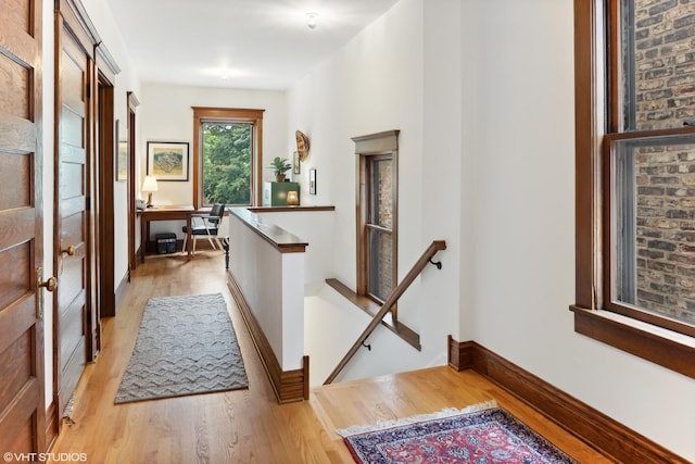 2645 N Mozart St, Chicago, IL 60647 - hall featuring an upstairs landing, light wood-style flooring, a desk, and baseboards