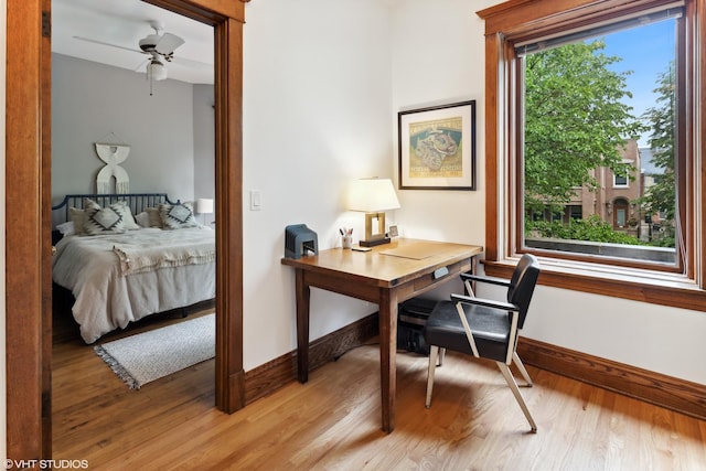 2645 N Mozart St, Chicago, IL 60647 - home office featuring baseboards, light wood-style flooring, and ceiling fan