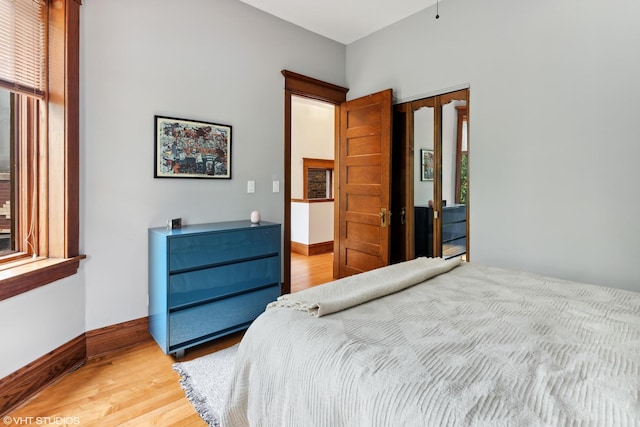 2645 N Mozart St, Chicago, IL 60647 - bedroom featuring light wood finished floors, baseboards, and a closet