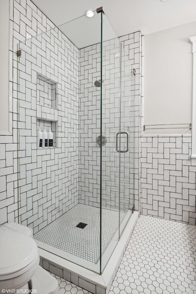 2645 N Mozart St, Chicago, IL 60647 - bathroom featuring a stall shower, toilet, and tile patterned floors