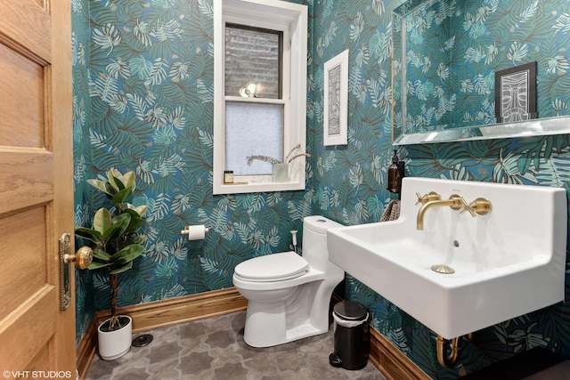 2645 N Mozart St, Chicago, IL 60647 - bathroom with wallpapered walls, baseboards, toilet, and a sink