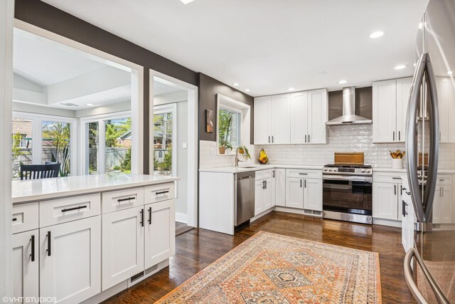 1232 Blackthorn Ln, Deerfield, IL 60015 - kitchen featuring appliances with stainless steel finishes, wall chimney range hood, a sink, light countertops, and backsplash