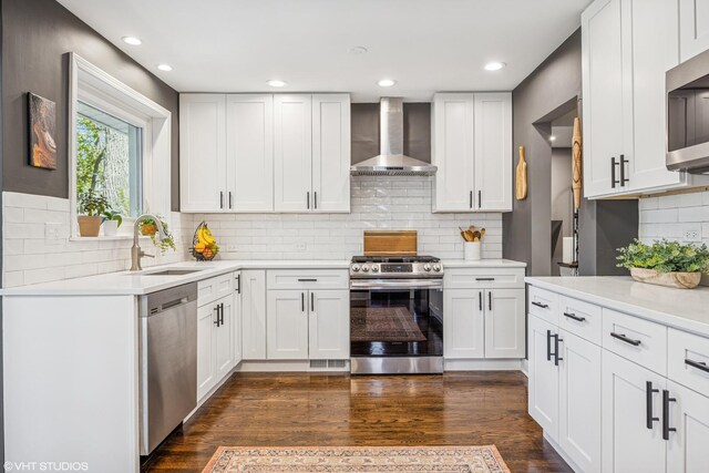 1232 Blackthorn Ln, Deerfield, IL 60015 - kitchen featuring wall chimney range hood, stainless steel appliances, a sink, decorative backsplash, and light countertops