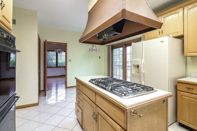 8341 84th Ct, Hickory Hills, IL 60457 - kitchen with premium range hood, stainless steel gas cooktop, light countertops, light brown cabinets, and light tile patterned floors