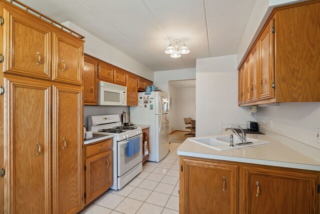13935 Le Claire Ave Unit 306, Crestwood, IL 60418 - kitchen with white appliances, a sink, light tile patterned floors, and brown cabinetry