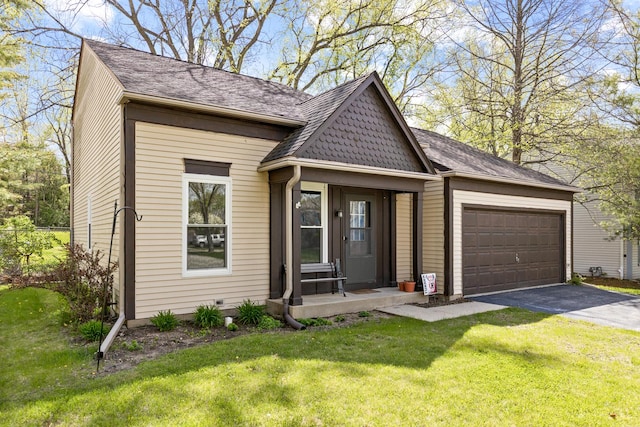 view of front of property featuring asphalt driveway, an attached garage, and a shingled roof