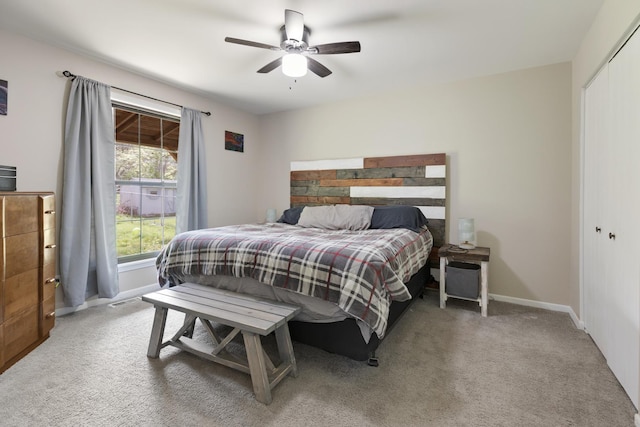 carpeted bedroom with baseboards, a closet, and a ceiling fan