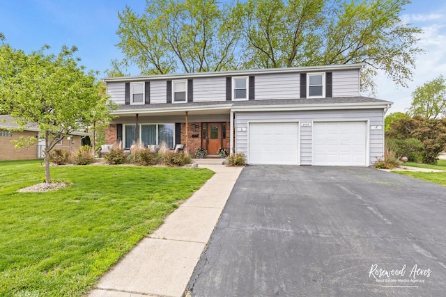 traditional-style house featuring driveway, an attached garage, and a front yard