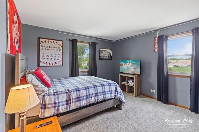 carpeted bedroom with baseboards