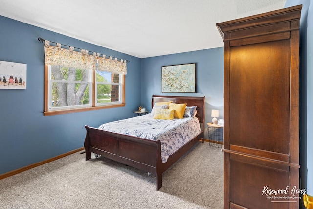 bedroom with carpet and baseboards
