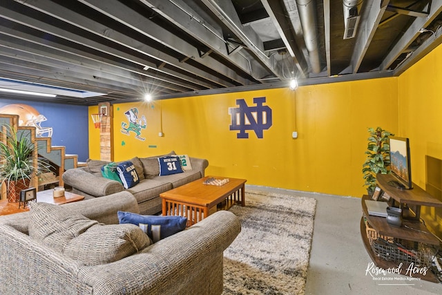 living area with stairs and concrete floors