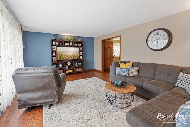 living room with wood finished floors and baseboards