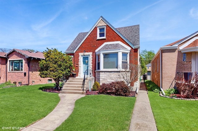 view of front of house featuring stone siding, roof with shingles, and a front yard