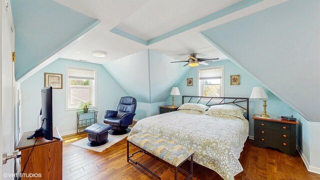 bedroom featuring hardwood / wood-style floors, a ceiling fan, vaulted ceiling, and baseboards