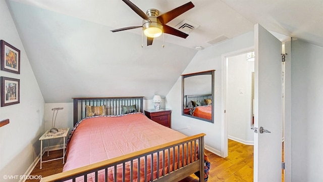 bedroom with vaulted ceiling, wood finished floors, baseboards, and a ceiling fan