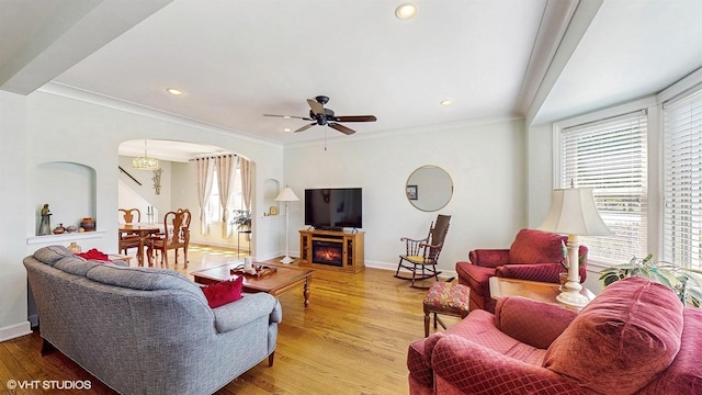 living area with arched walkways, wood finished floors, a ceiling fan, baseboards, and recessed lighting