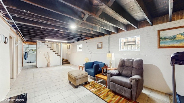 basement with tile patterned floors and stairway