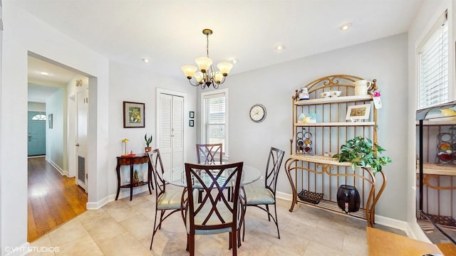 dining room featuring a chandelier, plenty of natural light, baseboards, and recessed lighting