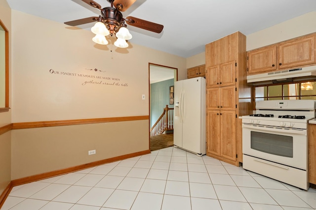 kitchen featuring white appliances, under cabinet range hood, a ceiling fan, and baseboards