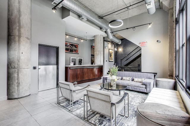 411 W Ontario St Unit 311, Chicago, IL 60654 - living room featuring tile patterned floors, stairway, and a towering ceiling