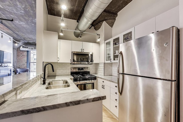 411 W Ontario St Unit 311, Chicago, IL 60654 - kitchen featuring a sink, stainless steel appliances, white cabinetry, glass insert cabinets, and light stone countertops