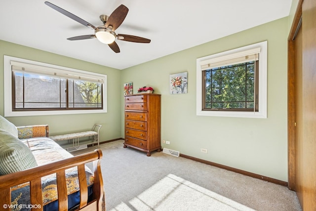 carpeted bedroom with baseboards and a ceiling fan