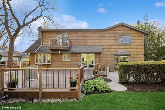 back of house with a balcony, a wooden deck, and a shingled roof