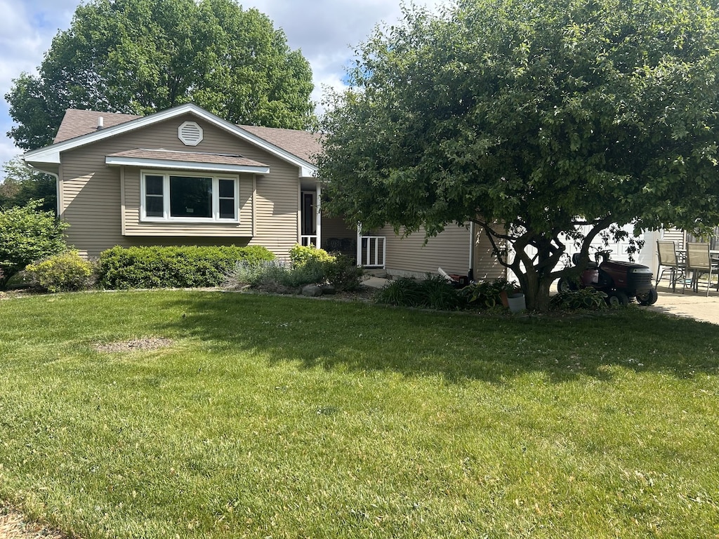 137 W Sixth Pl, Manteno, IL 60950 - view of front of property with a front lawn, a shingled roof, and a patio
