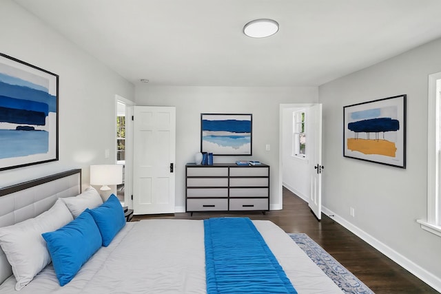 bedroom with wood finished floors and baseboards