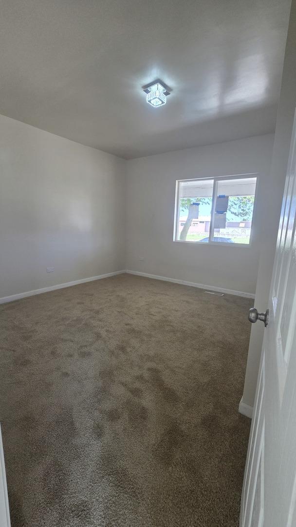 301 N W Ave, Kankakee, IL 60901 - empty room featuring carpet flooring and baseboards