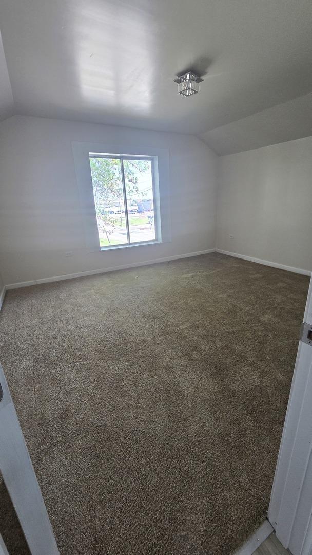 301 N W Ave, Kankakee, IL 60901 - bonus room with vaulted ceiling, carpet floors, and baseboards