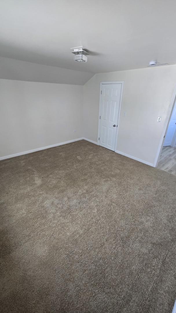 301 N W Ave, Kankakee, IL 60901 - carpeted empty room featuring baseboards