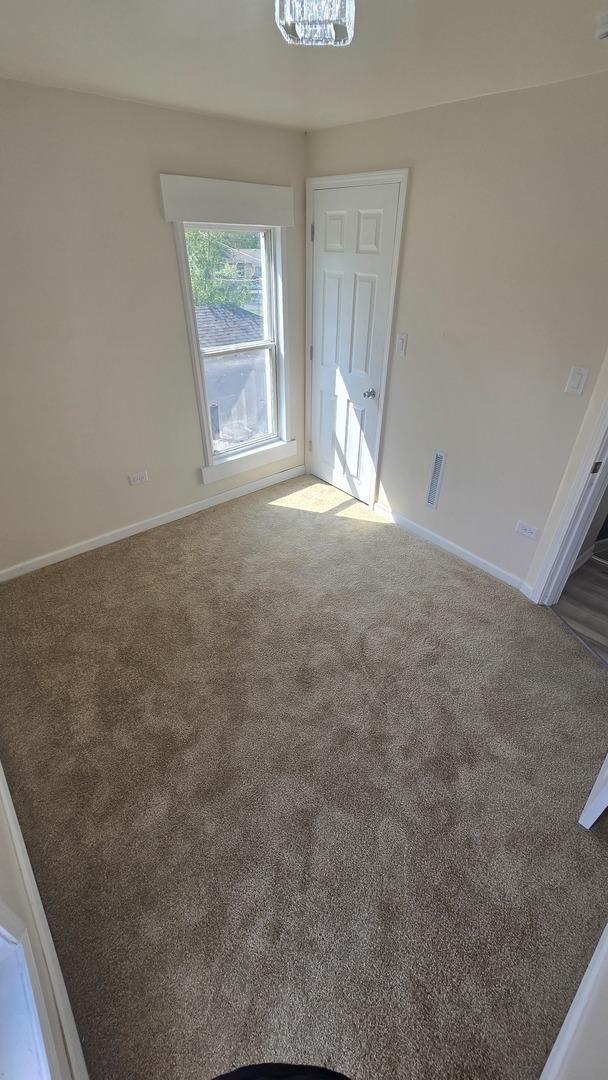 301 N W Ave, Kankakee, IL 60901 - unfurnished room with carpet floors and baseboards