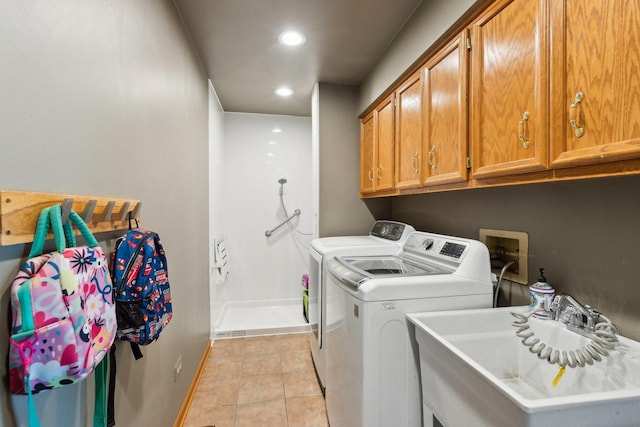 laundry room with washer and clothes dryer, baseboards, cabinet space, light tile patterned floors, and recessed lighting