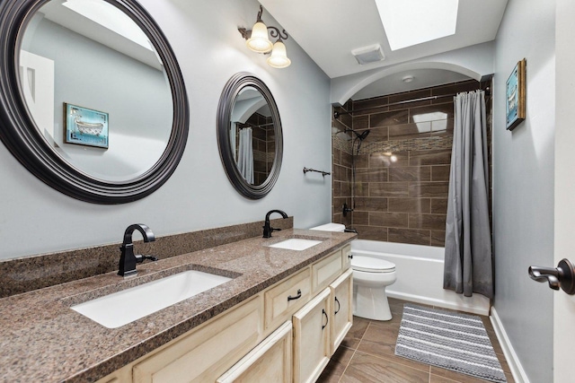 bathroom with toilet, double vanity, shower / tub combo, tile patterned floors, and baseboards