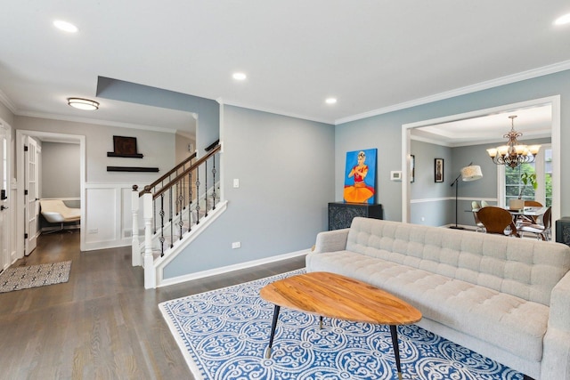 living area with a chandelier, wood finished floors, crown molding, stairway, and recessed lighting