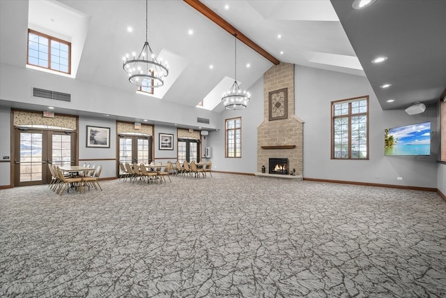 living room with high vaulted ceiling, carpet, baseboards, beam ceiling, and a large fireplace