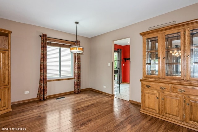 1270 Chattanooga Trl, Carol Stream, IL 60188 - unfurnished dining area with plenty of natural light, baseboards, and wood finished floors