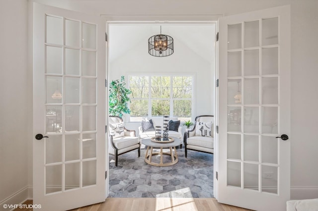 living area with an inviting chandelier and wood finished floors