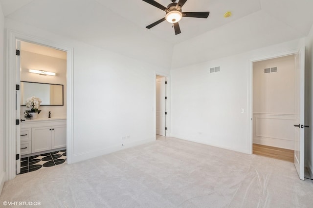 unfurnished bedroom featuring carpet flooring, connected bathroom, and visible vents