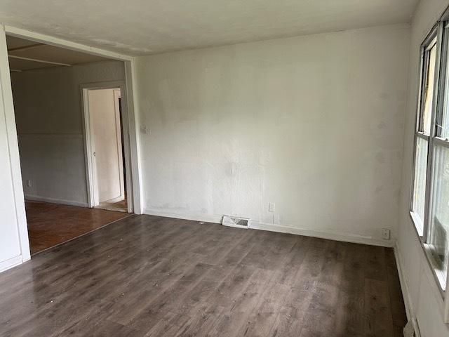 21 Westwood Dr, Cahokia, IL 62206 - spare room with baseboards, visible vents, and dark wood-style floors