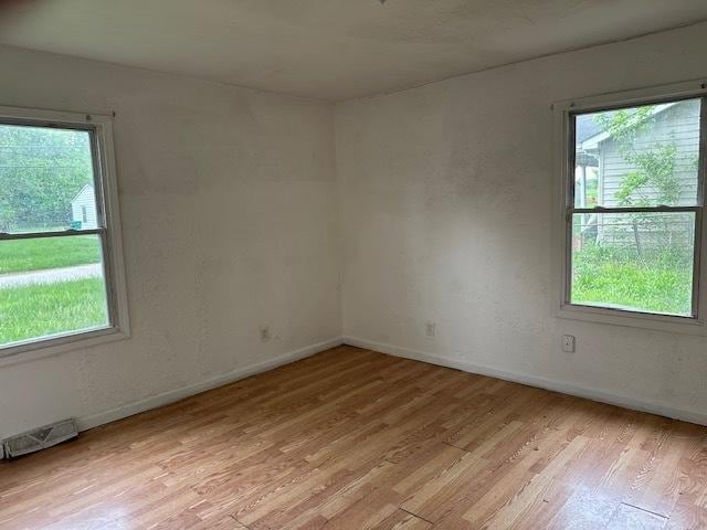 21 Westwood Dr, Cahokia, IL 62206 - spare room featuring baseboards, light wood-style floors, a healthy amount of sunlight, and visible vents
