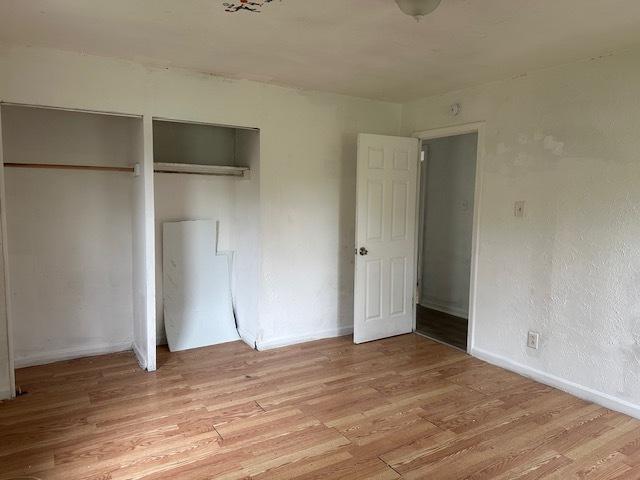 21 Westwood Dr, Cahokia, IL 62206 - unfurnished bedroom featuring baseboards and light wood-type flooring