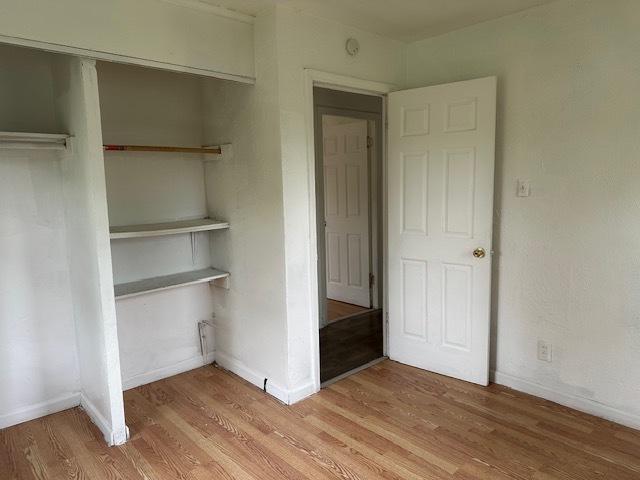 21 Westwood Dr, Cahokia, IL 62206 - unfurnished bedroom with a closet, light wood-style floors, and baseboards