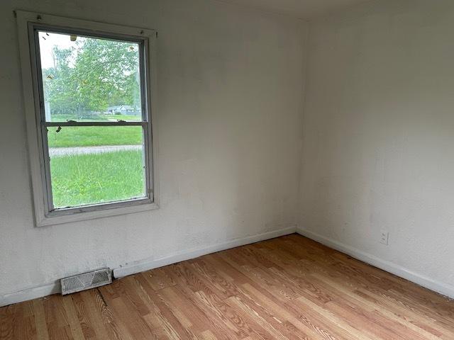 21 Westwood Dr, Cahokia, IL 62206 - unfurnished room featuring a healthy amount of sunlight, light wood-style flooring, baseboards, and visible vents