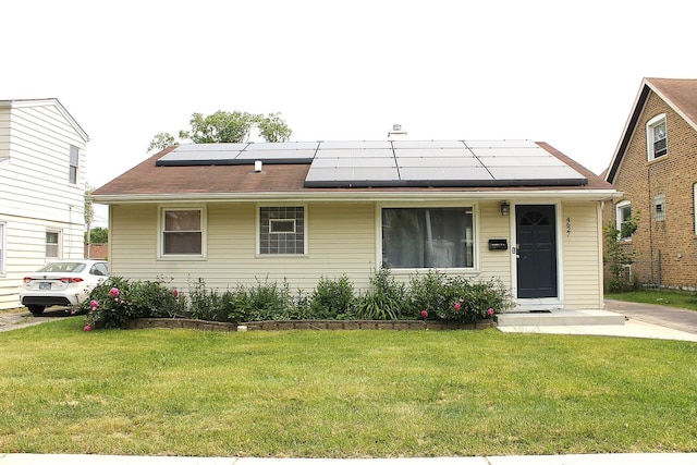 4627 Custer Ave, Lyons, IL 60534 - view of front of home featuring a front lawn and roof mounted solar panels