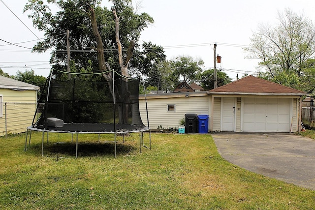 4627 Custer Ave, Lyons, IL 60534 - view of green lawn with a trampoline, a garage, and an outbuilding